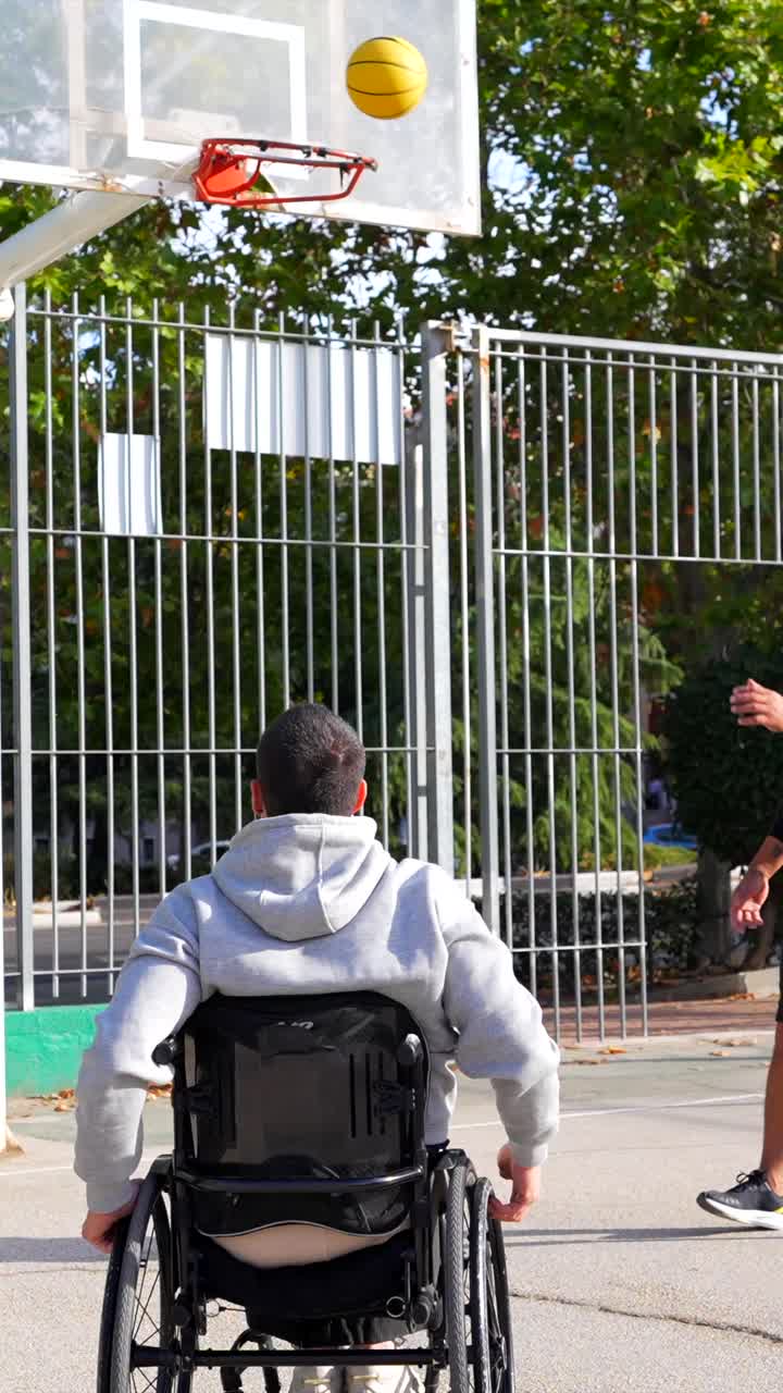 A Man in a Wheelchair Playing Basketball Outdoors
