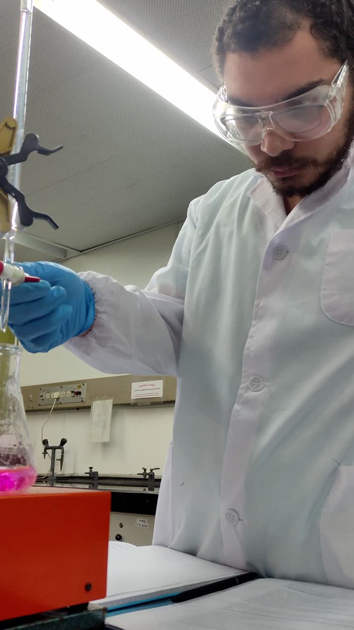 Chemist Wearing Gloves Handling Lab Equipment