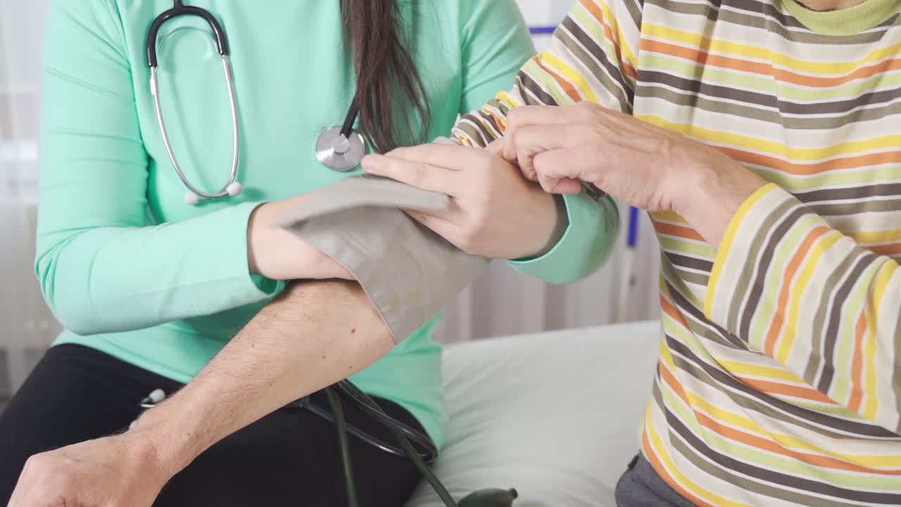 The patient's blood pressure is measured.