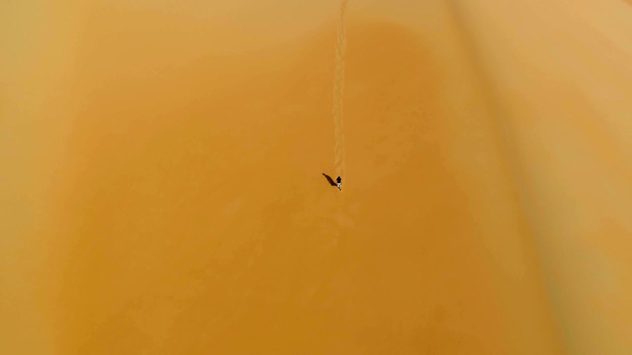 해가 지는 동안 모래 언덕을 고 있는 남자 의 공중 사진, u.a.e.