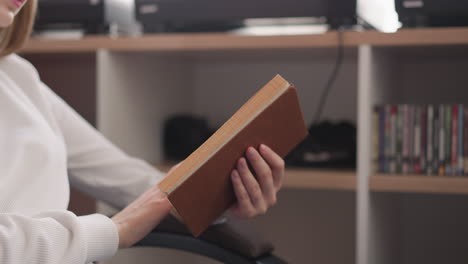 woman reading a book in a library