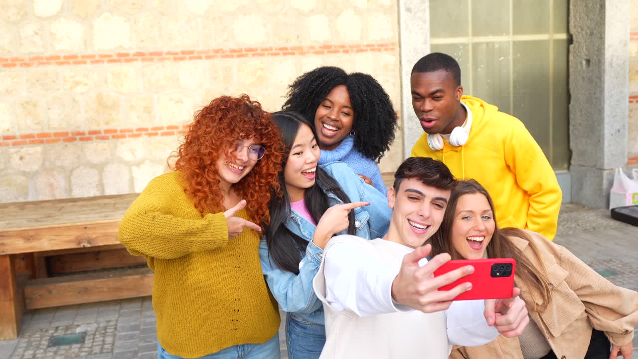 Group of diverse friends taking a selfie outdoors