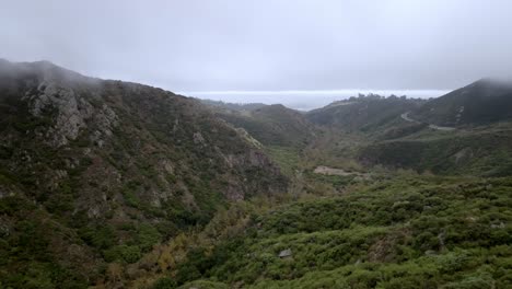 Santa-Monica-Mountains-in-Malibu,-California-on-cloudy-day-with-drone-video-moving-forward-and-up