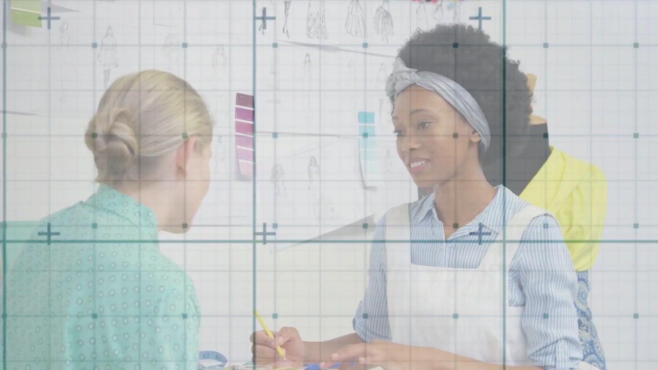 Right designer drawing pencil left peer leaning in grid aligning swatches near mannequin for design