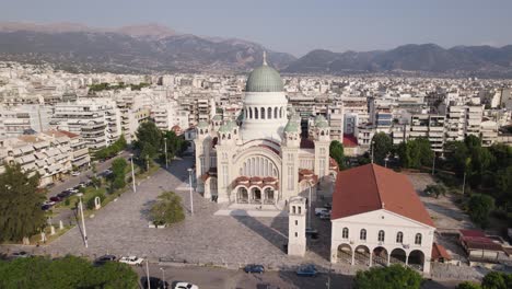 Establishing-shot-of-Scenic-Cathedral-of-Saint-Andrew-in-Patras,-Cityscape-and-mountains-in-Background