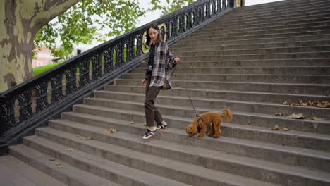 woman walking her dog down a set of stairs