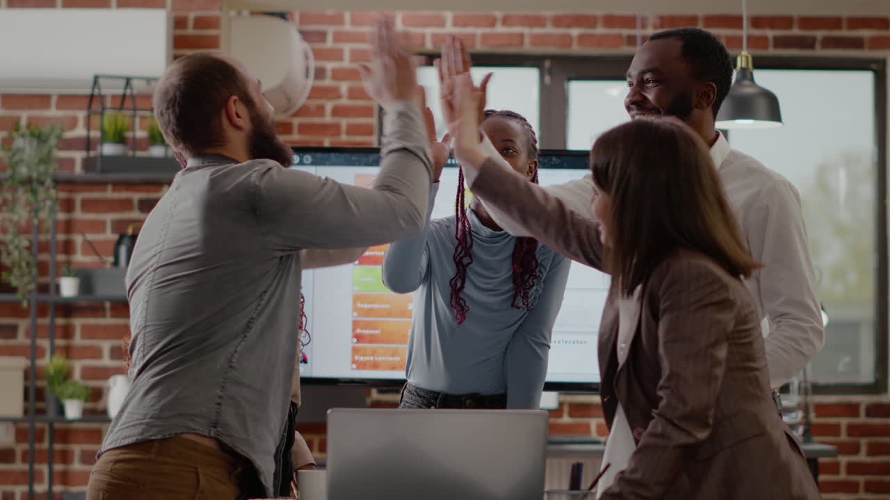 Business people joining hands in unity after big project win