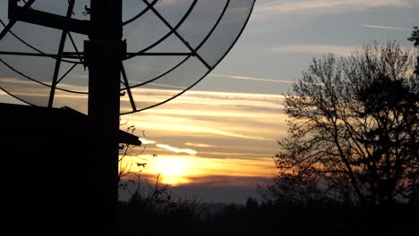 beautiful cloudy sunset with a transmission mast in foreground