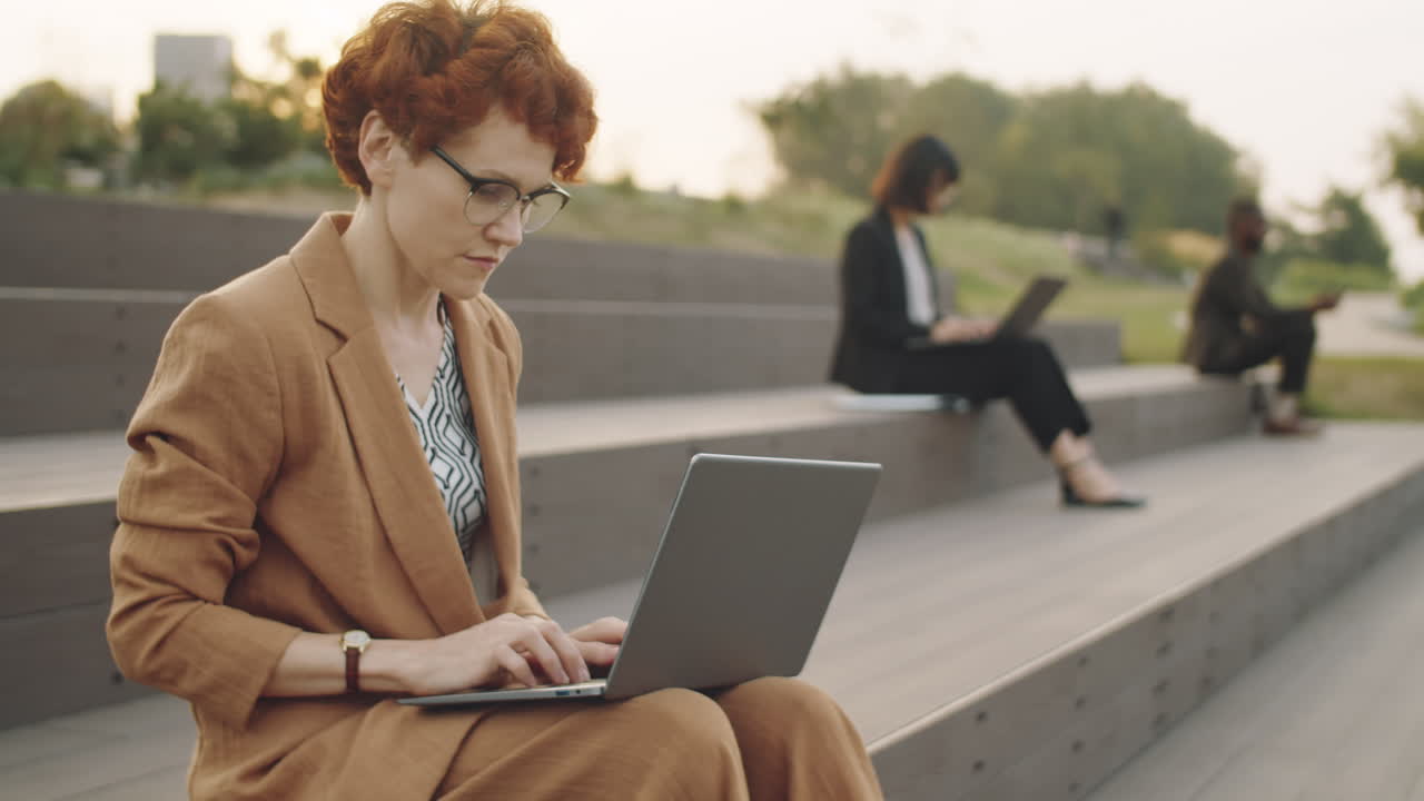 Businesswoman Using Laptop in Park
