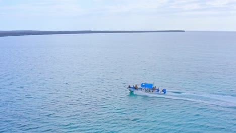 White-and-blue-speedboat-with-tourists-sailing-on-Caribbean-sea