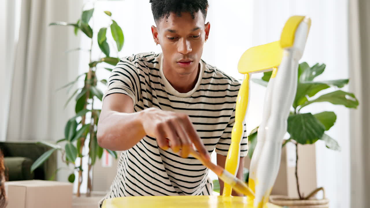 Man painting a chair in a home interior