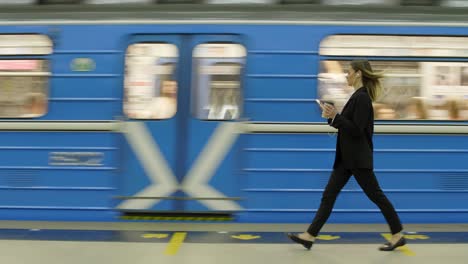 female manager with headphones arriving on underground station