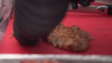 chef cutting a grilled steak