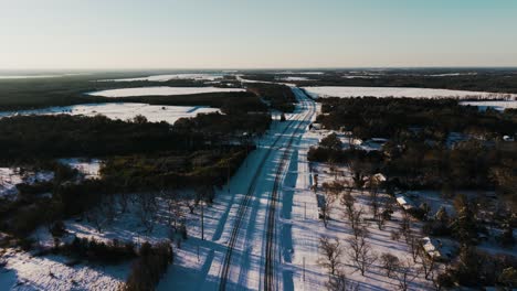 a dynamic drone shot swiftly pushing in over a snow-covered highway in south georgia. captured during a rare snowfall, this unique perspective showcases winter's serene beauty.
