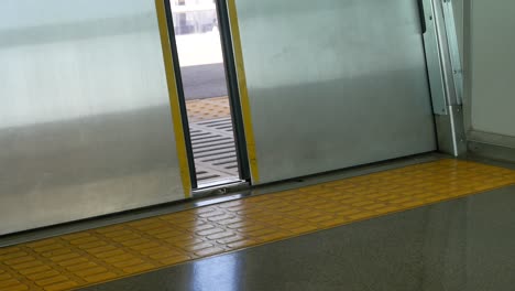 Lower view of the japan train's door while door is closing