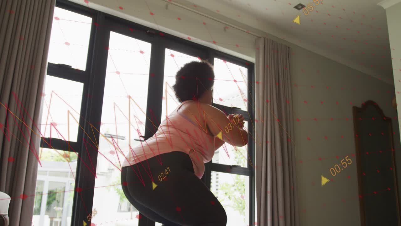 Woman doing timed fitness squats in living-room, onscreen timer guiding form with mat and dumbbells