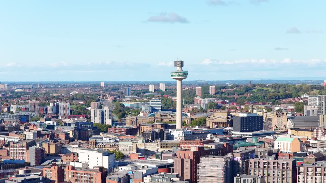 Stunning cinematic drone footage of Liverpool City Centre in northwest England, filmed during sunset. The golden-hour light highlights the iconic skyline and iconic radio tower