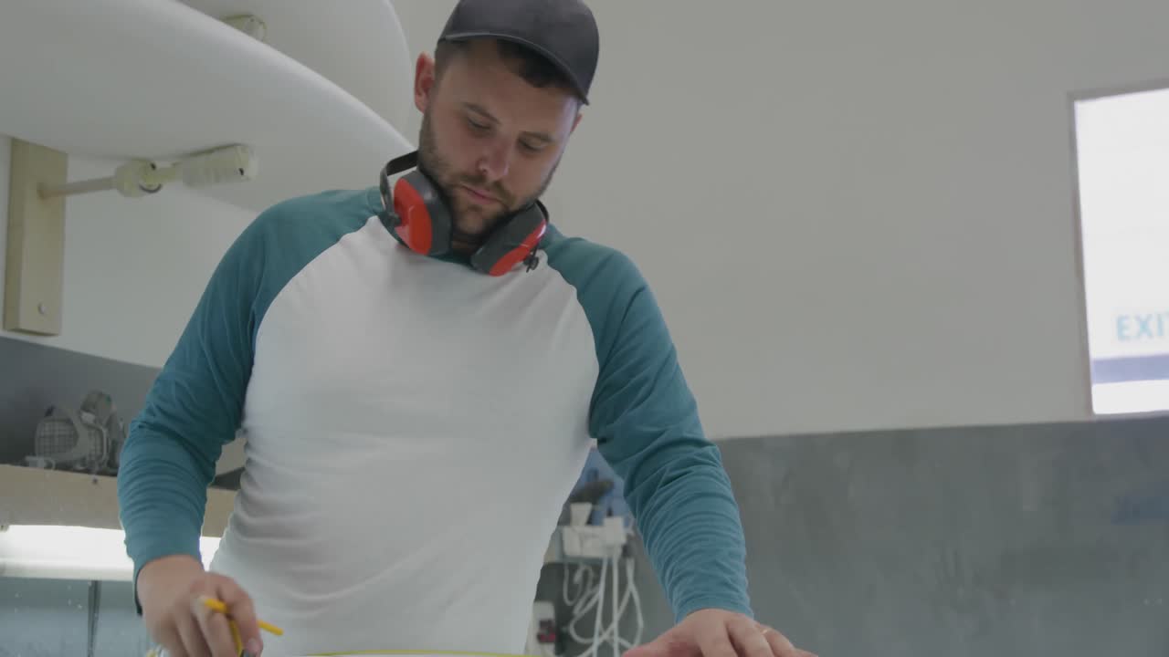Male surfboard maker in his workshop