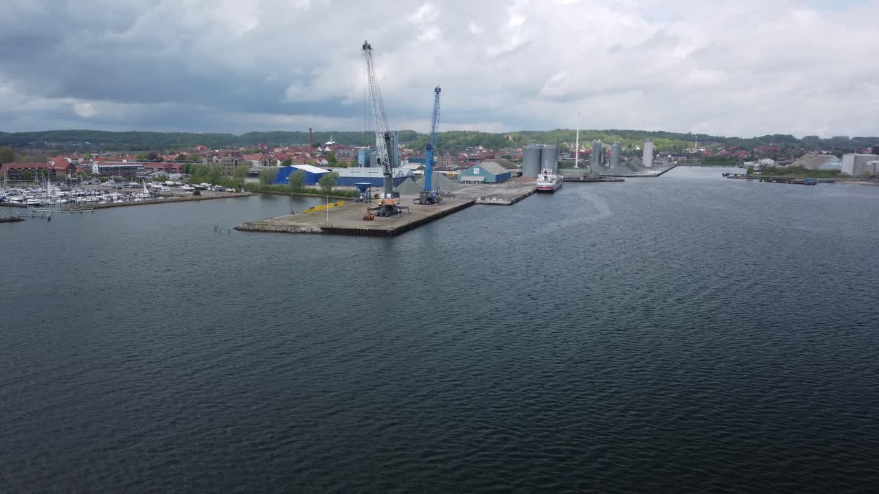 Orbital aerial of Aabenraa port, marina, and coastal town reveal view