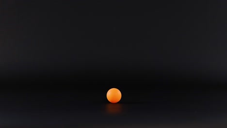 orange ball moves across a dark surface