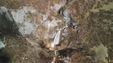 Majestic-top-down-view-of-water-cascade-on-the-cliffs,-waterfall-Skakavica,-Albania