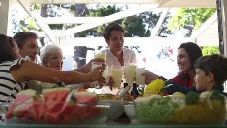 family eating outside together in summer