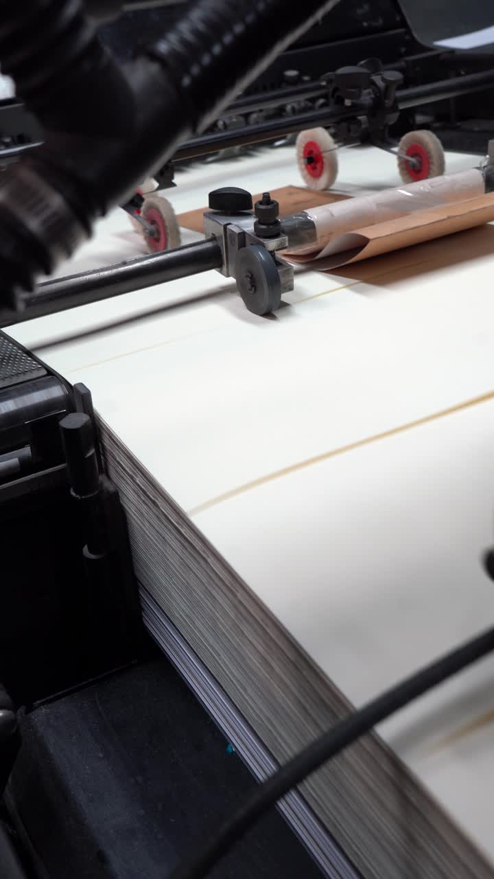 Industrial printer operates efficiently, moving paper with precision