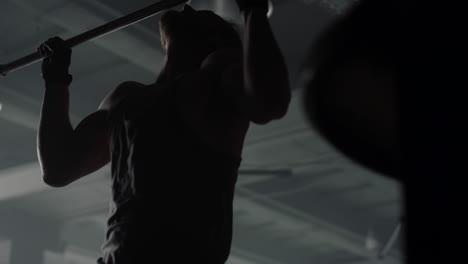 sportsman doing chin ups on bar. fit man making exercise for upper body