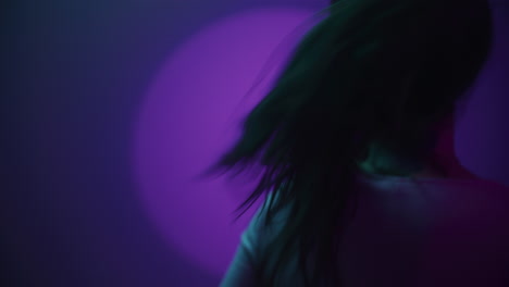 woman posing in a studio with colorful neon lighting
