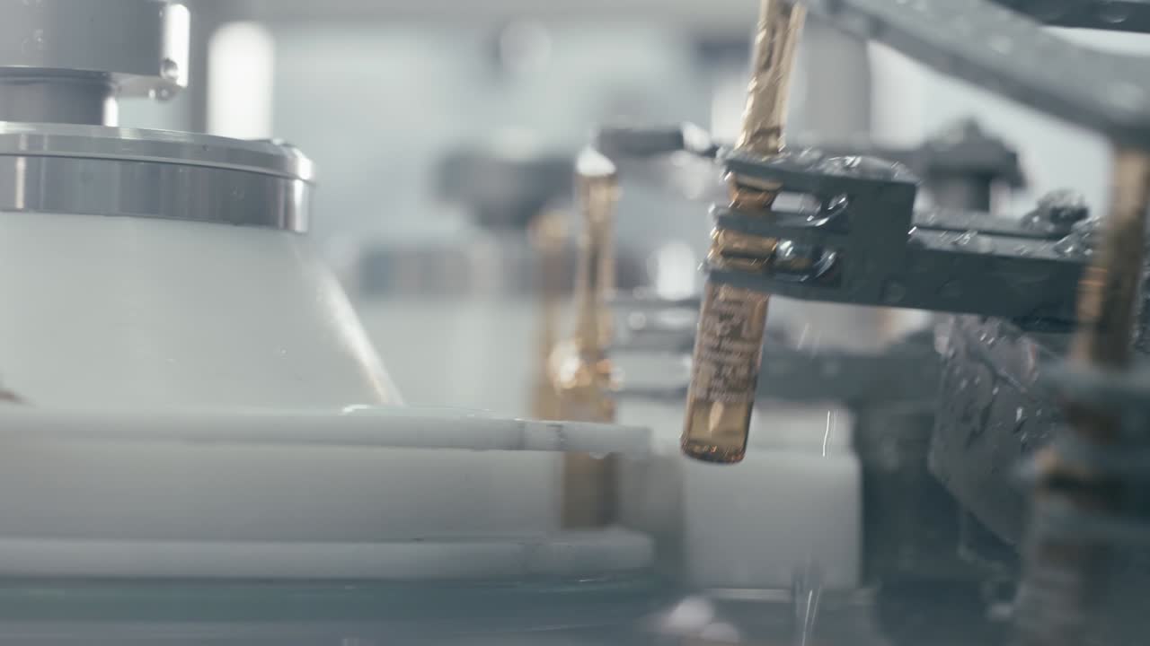 Conveyor rotating serum tubes in Modern pharmaceutical manufacturing plant