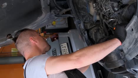 mechanic working on car engine