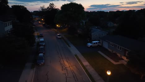 American-neighborhood-at-dusk-with-streetlight-and-car