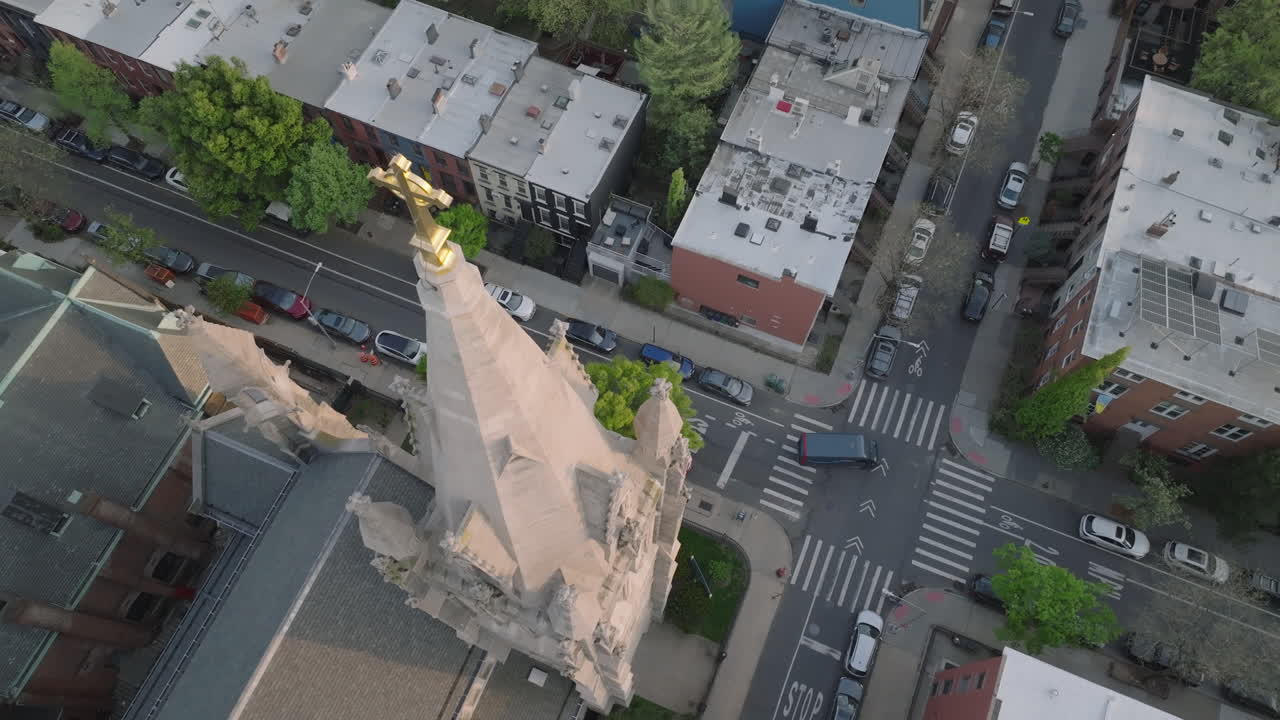 Aerial view of a crucifix on a church steeple in Brooklyn. Shot on a spring day.
