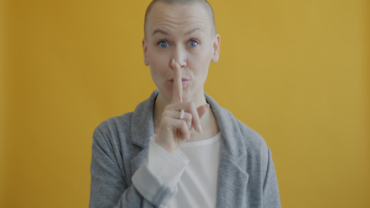 Woman with finger to lips