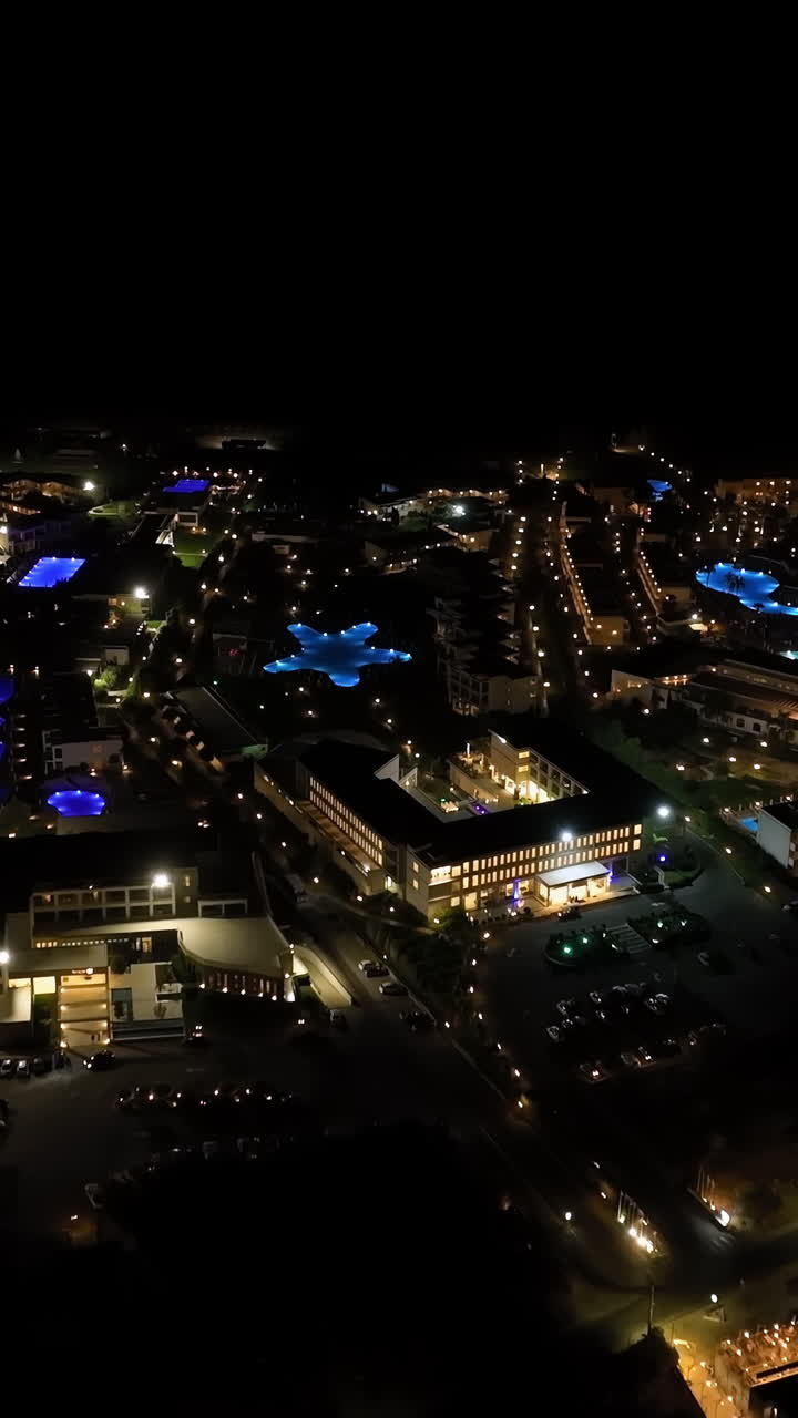Aerial portrait of illuminated hotels on the coastline of Rhodes, night in Greece