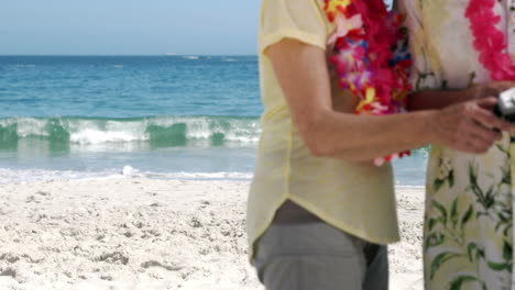 senior couple holding camera