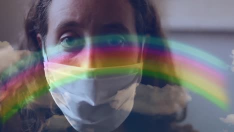 arco iris y cielo azul contra una mujer con una máscara facial