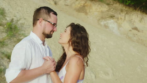 wet after a rain loving couple kissing on the beach hd video