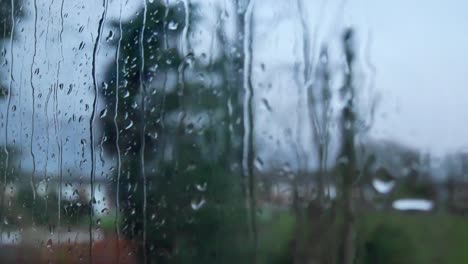 rainy storm droplets, moody weather fall down window glass closeup bokeh