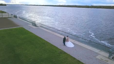 couple holding hands by the river