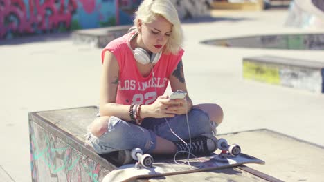 trendy young blond woman at a skate park