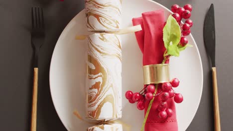 video of christmas place setting with christmas cracker on grey background