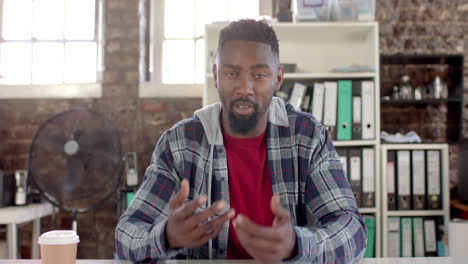 portrait of african american casual businessman having video call in office in slow motion
