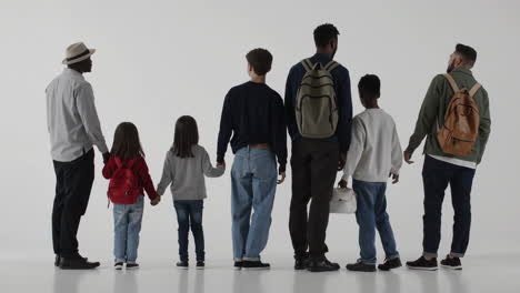 diverse group of people standing together holding hands on white background