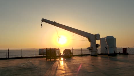 farry or ship crane at sunset