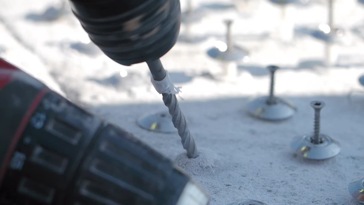 전력 드릴로 콘크리트에 나사를 설치하는 것