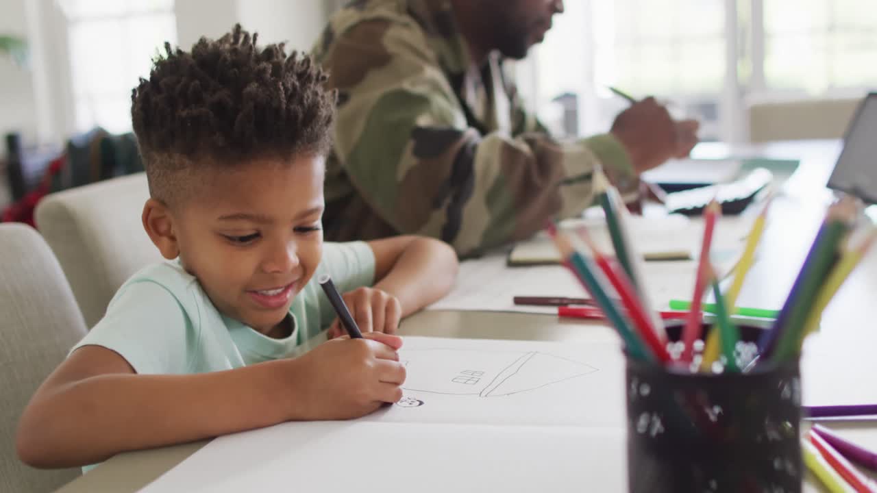 African american father with son learning together and writing