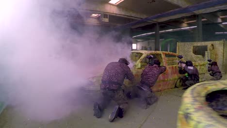 cameraman filming paintball players in a paintball arena on a steady cam