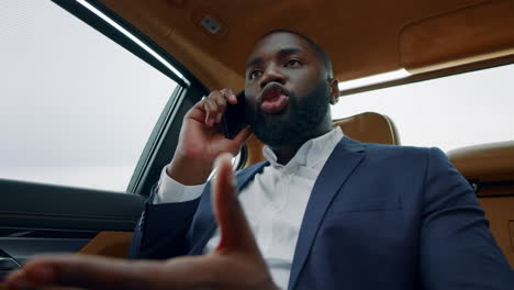 portrait of business man talking phone at car. afro man having phone call at car