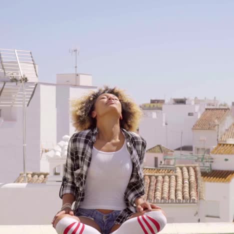 woman meditating on rooftop